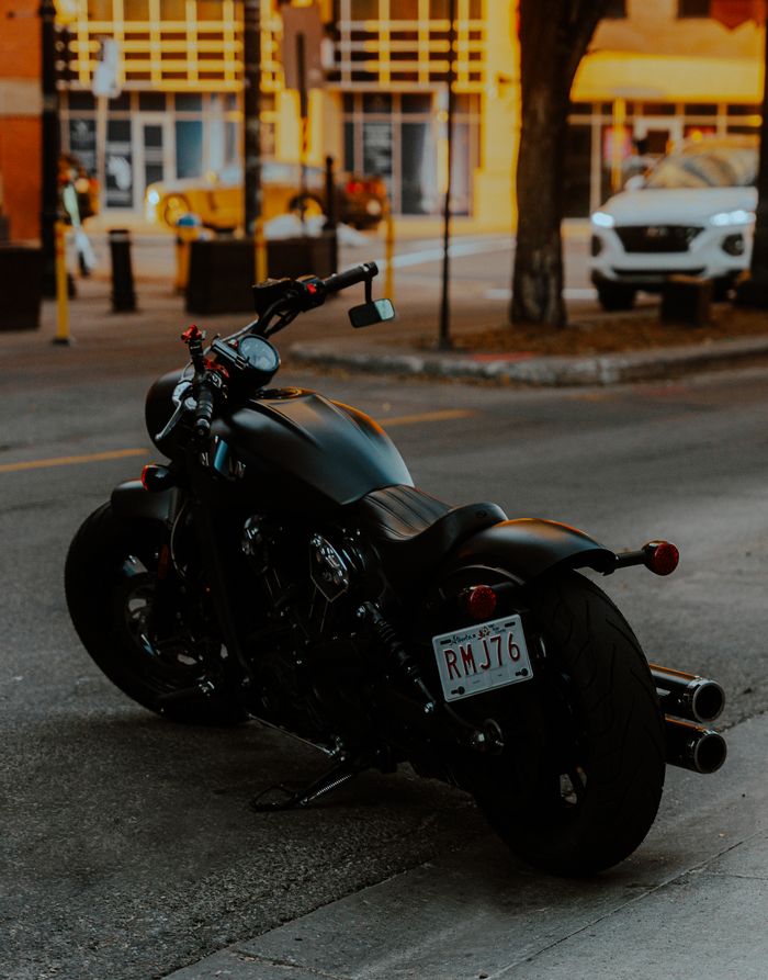 gallery-01 A black motorcycle parked on a street in Edmonton, Alberta, capturing urban life.