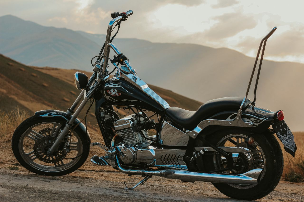 about-img-01 Custom chopper motorcycle parked in a scenic mountainous area in West Azerbaijan, Iran.